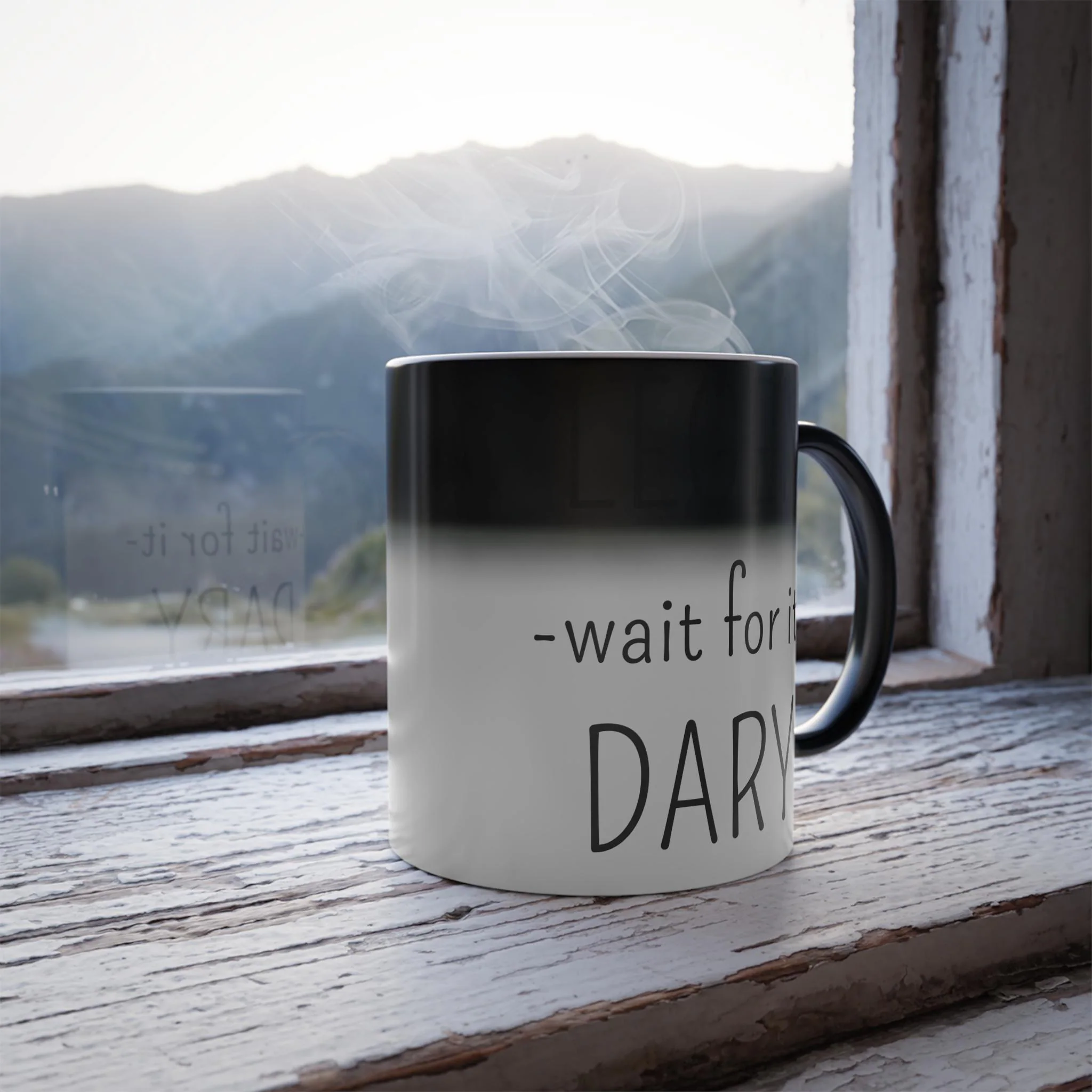 Heat sensitive color morphing mug showing black top transition to white bottom with wait for it text