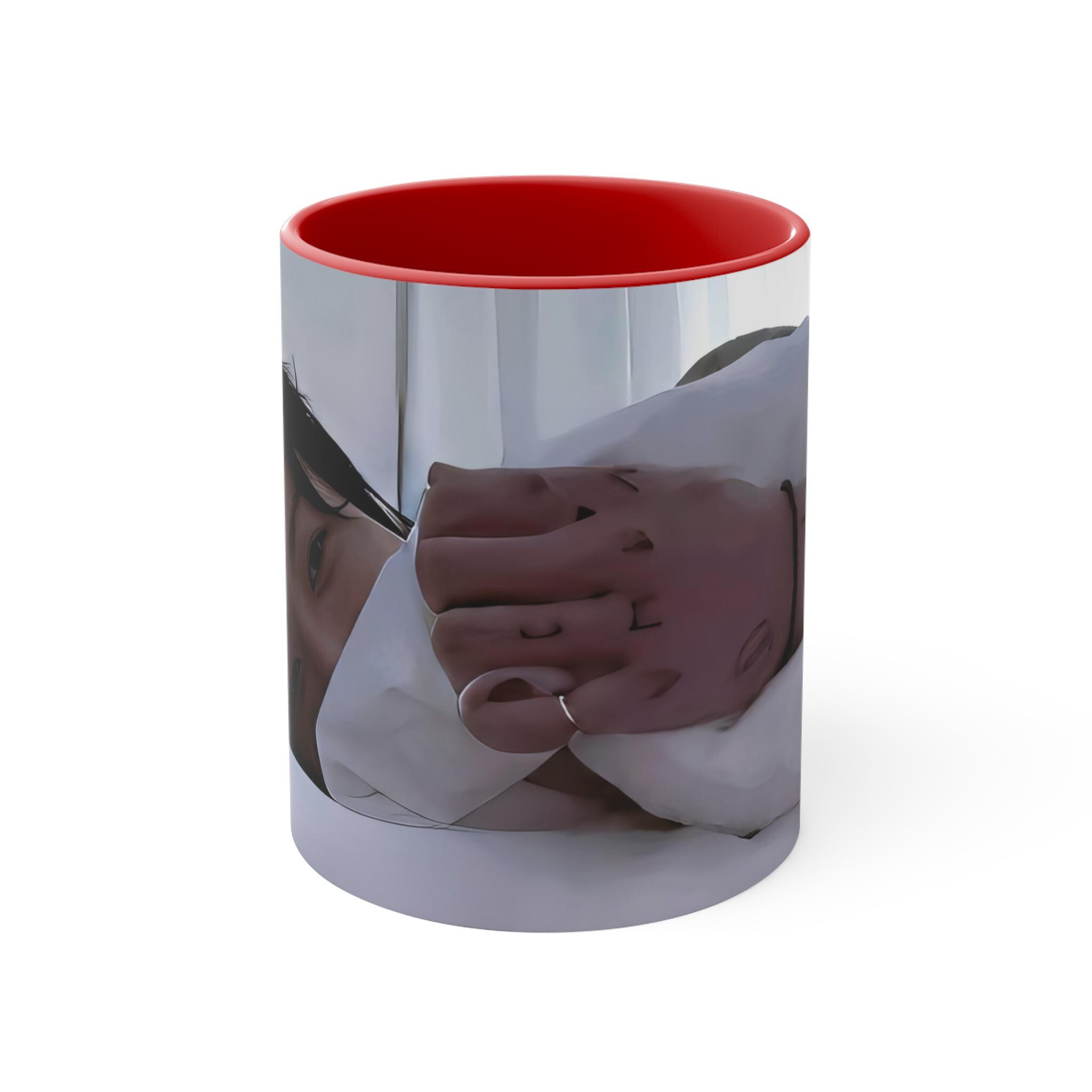 Side view of ceramic beverage cup with color handle and rim