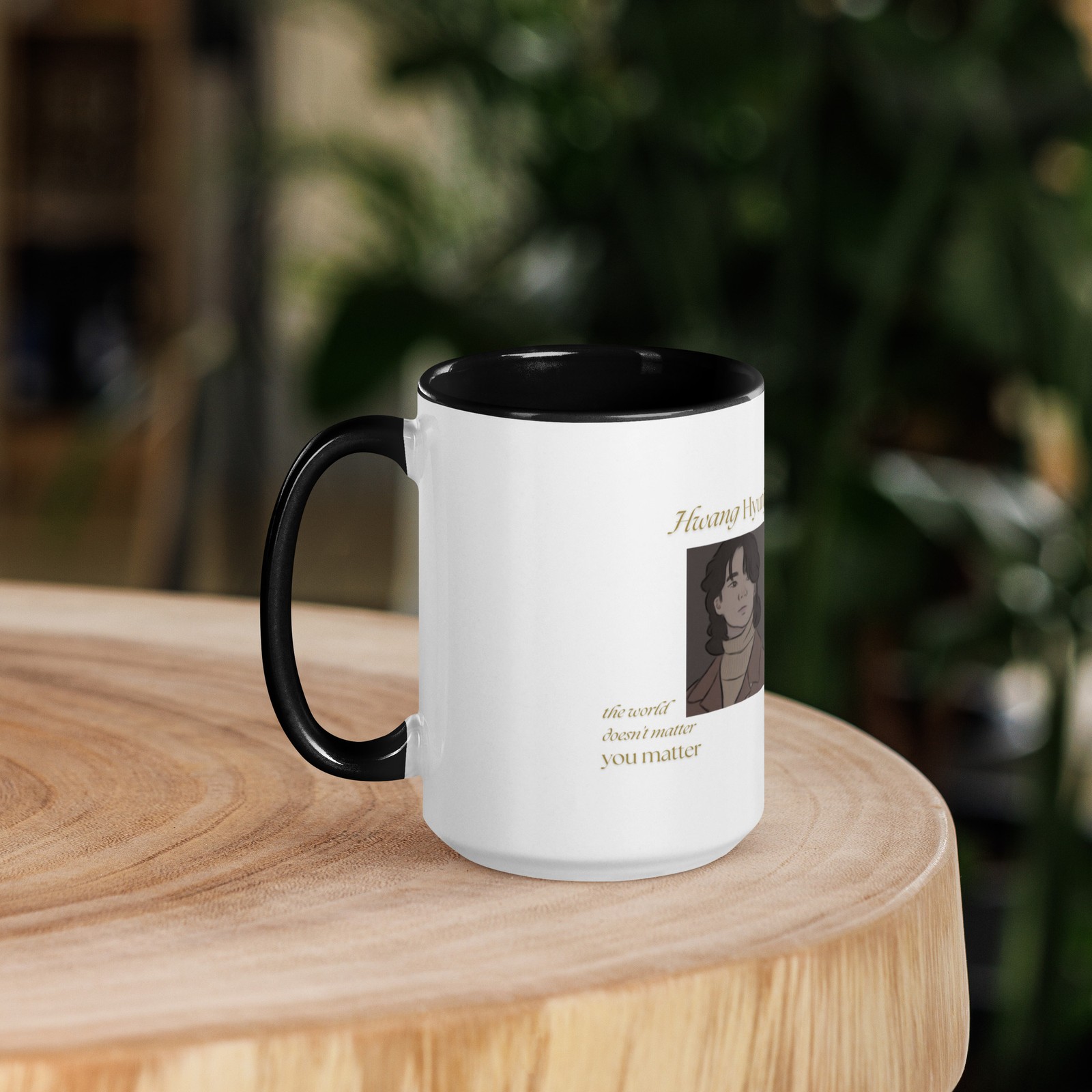 Side view of a white ceramic mug showing a portrait of Hyunjin and a black interior rim on a wooden table