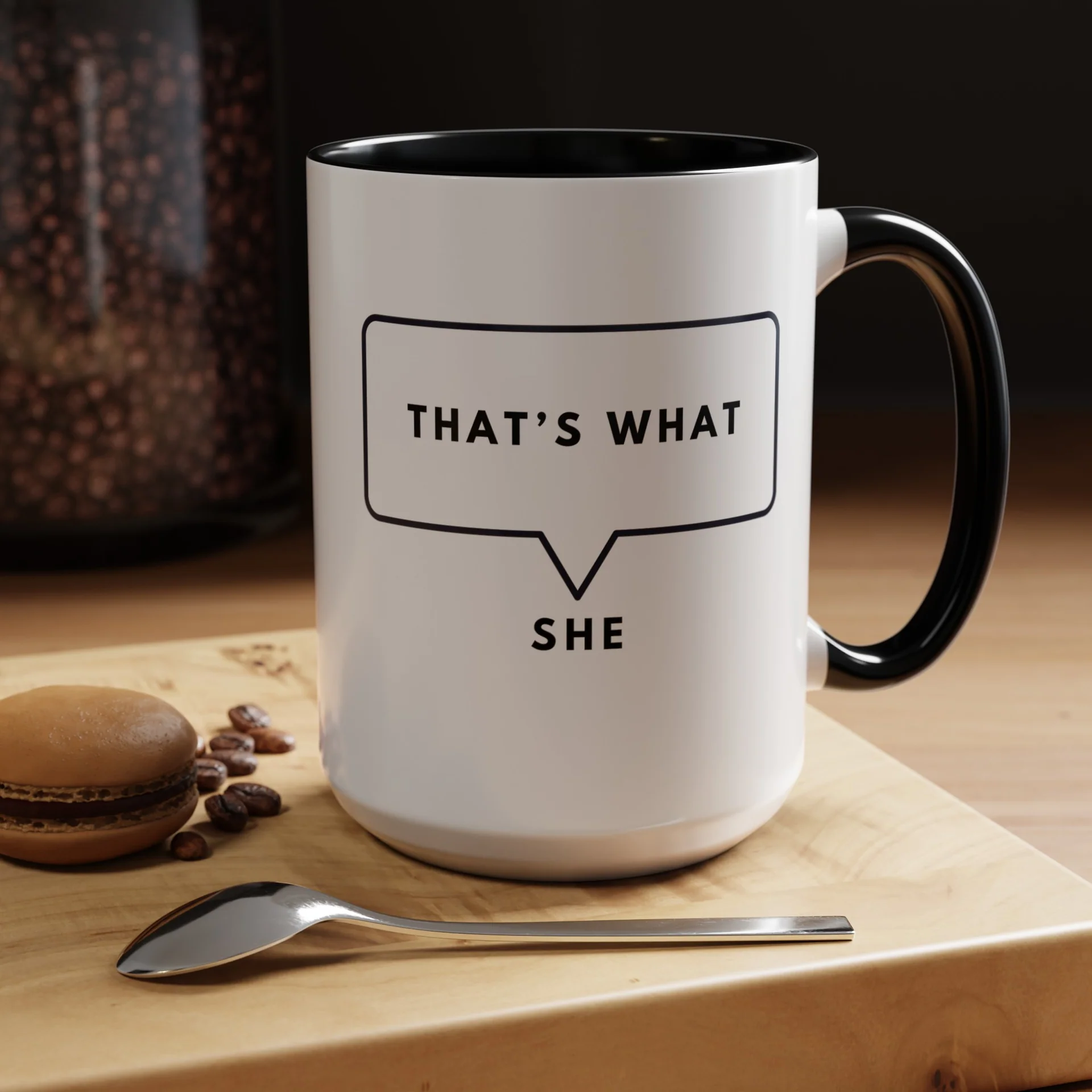 Side view of large 15 ounce ceramic mug with black accents and speech bubble quote on wooden surface