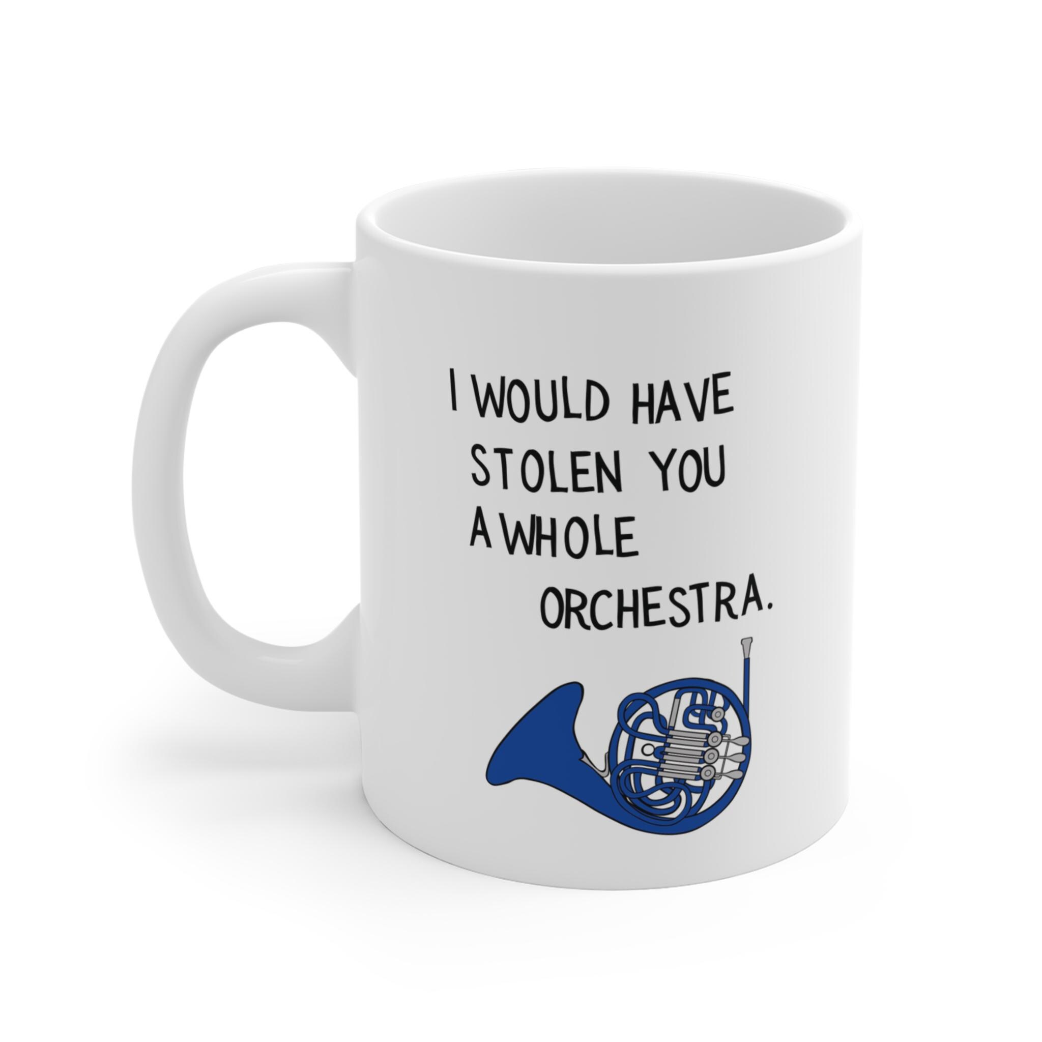 Close up of a white coffee mug with blue french horn musical instrument graphic and romantic quote from a popular show