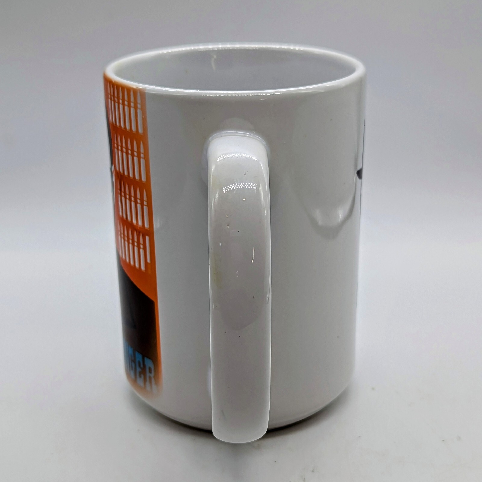 Side view of white ceramic mug showing large comfortable handle