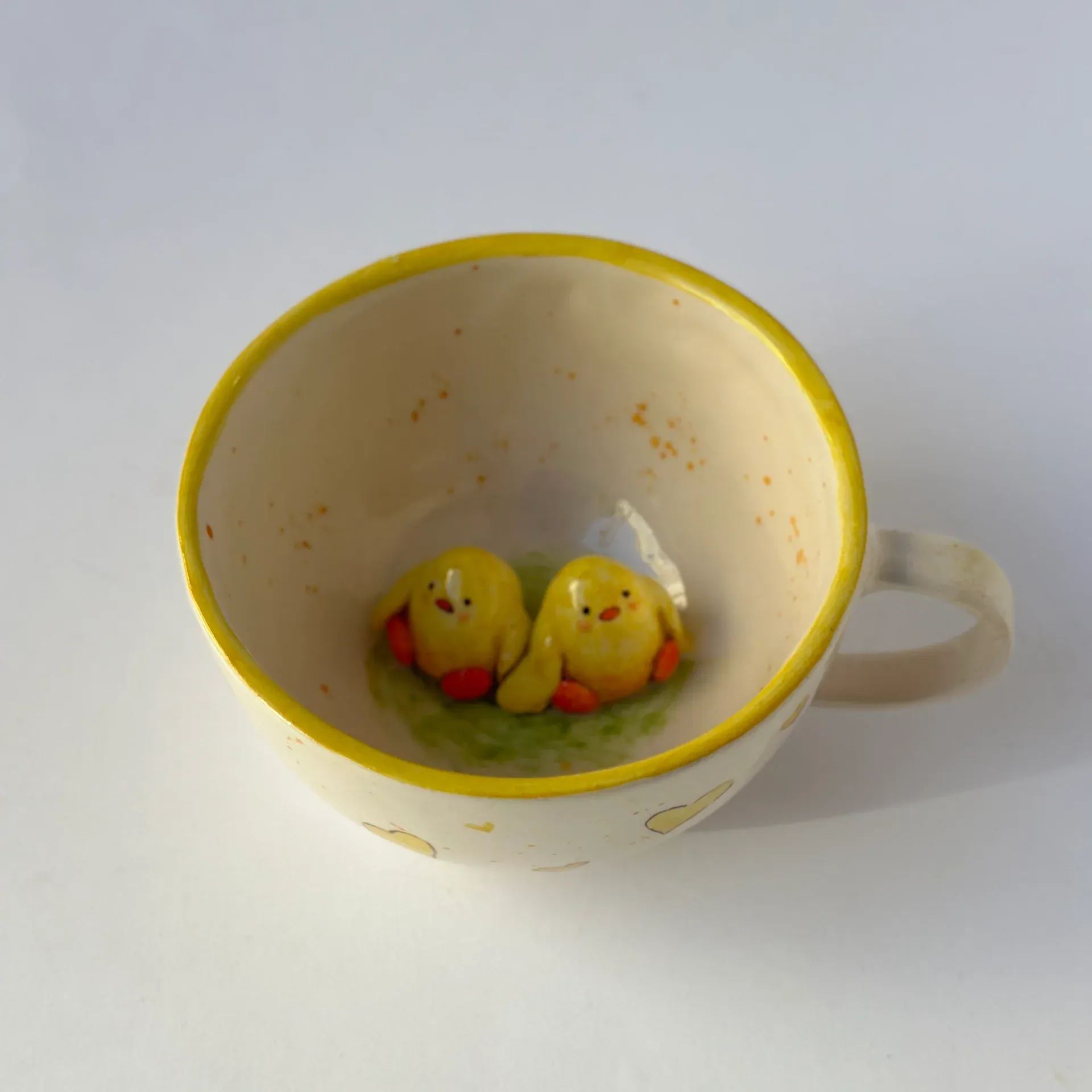 Handmade ceramic coffee mug with chick design