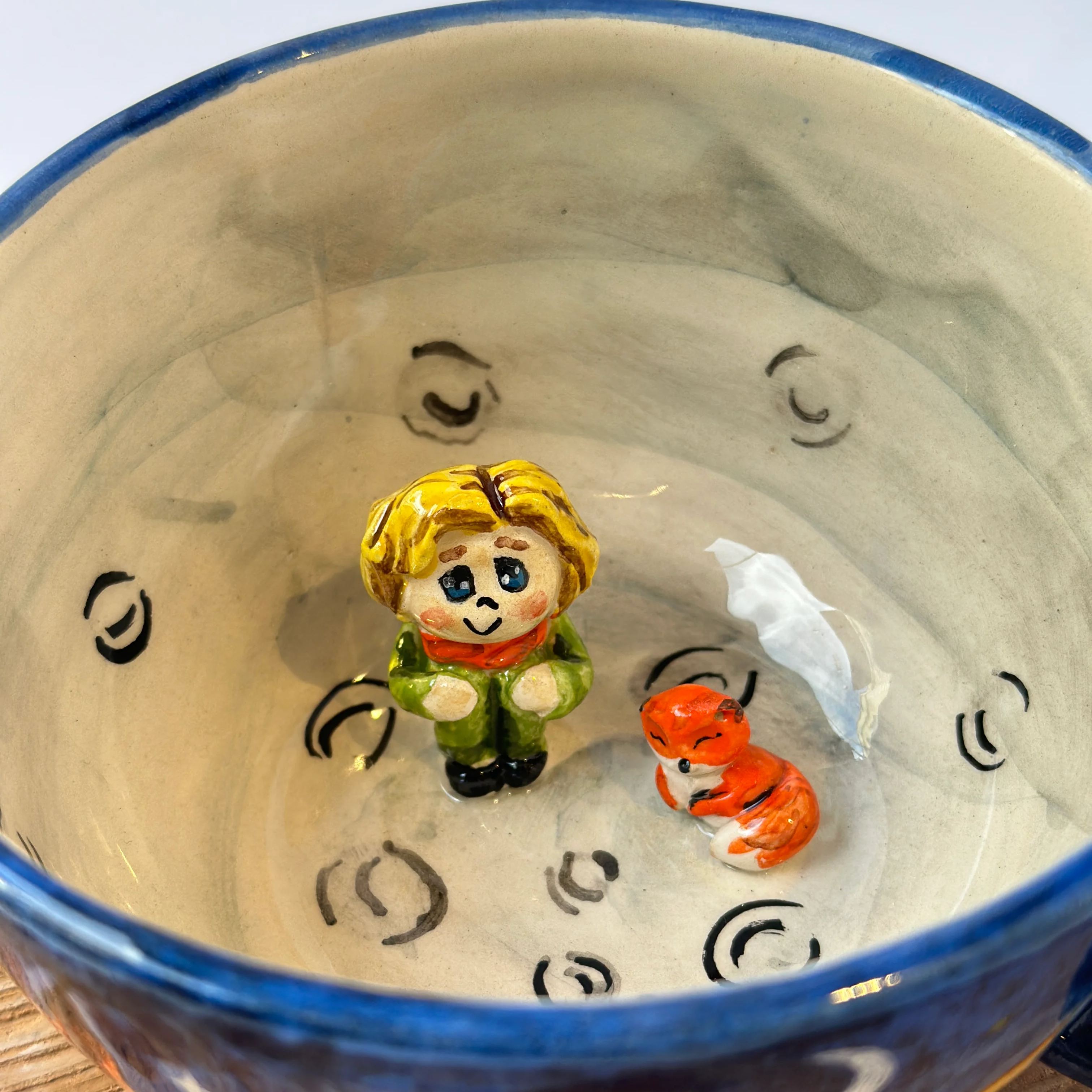 Glazed ceramic tea mug with hand painted details