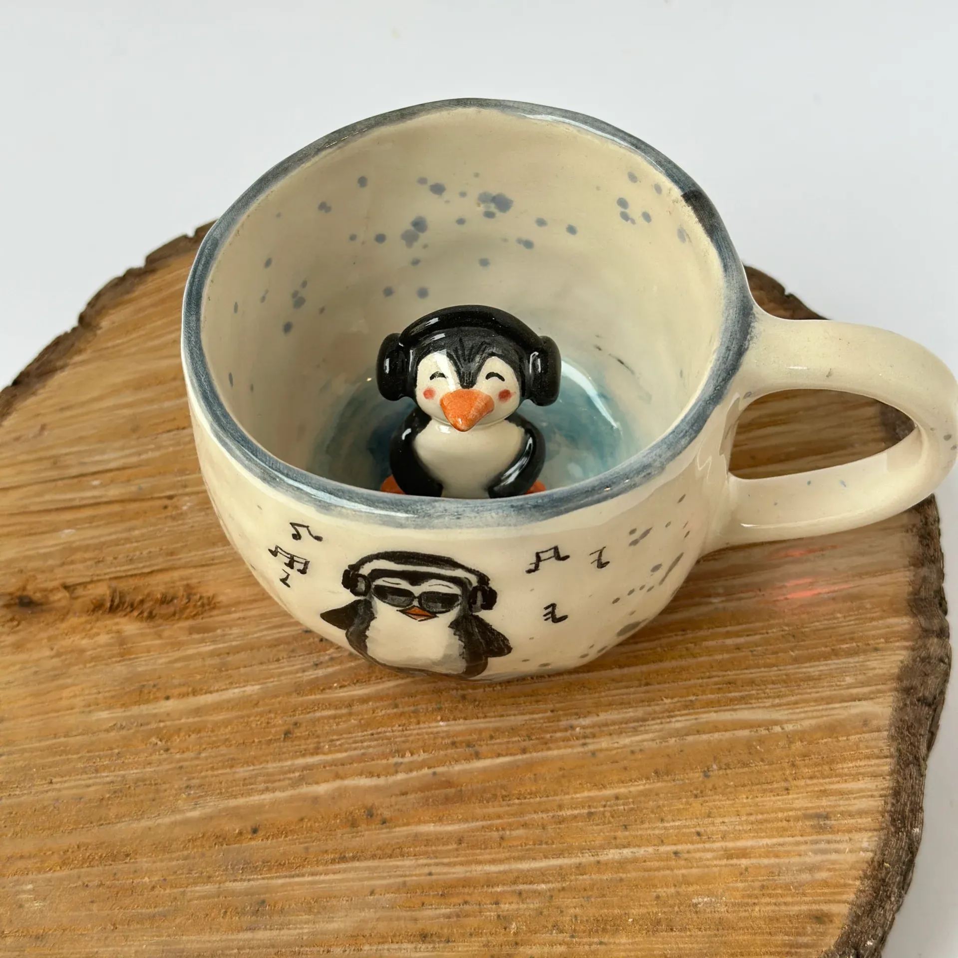 Handmade ceramic penguin shaped coffee mug with glossy glaze