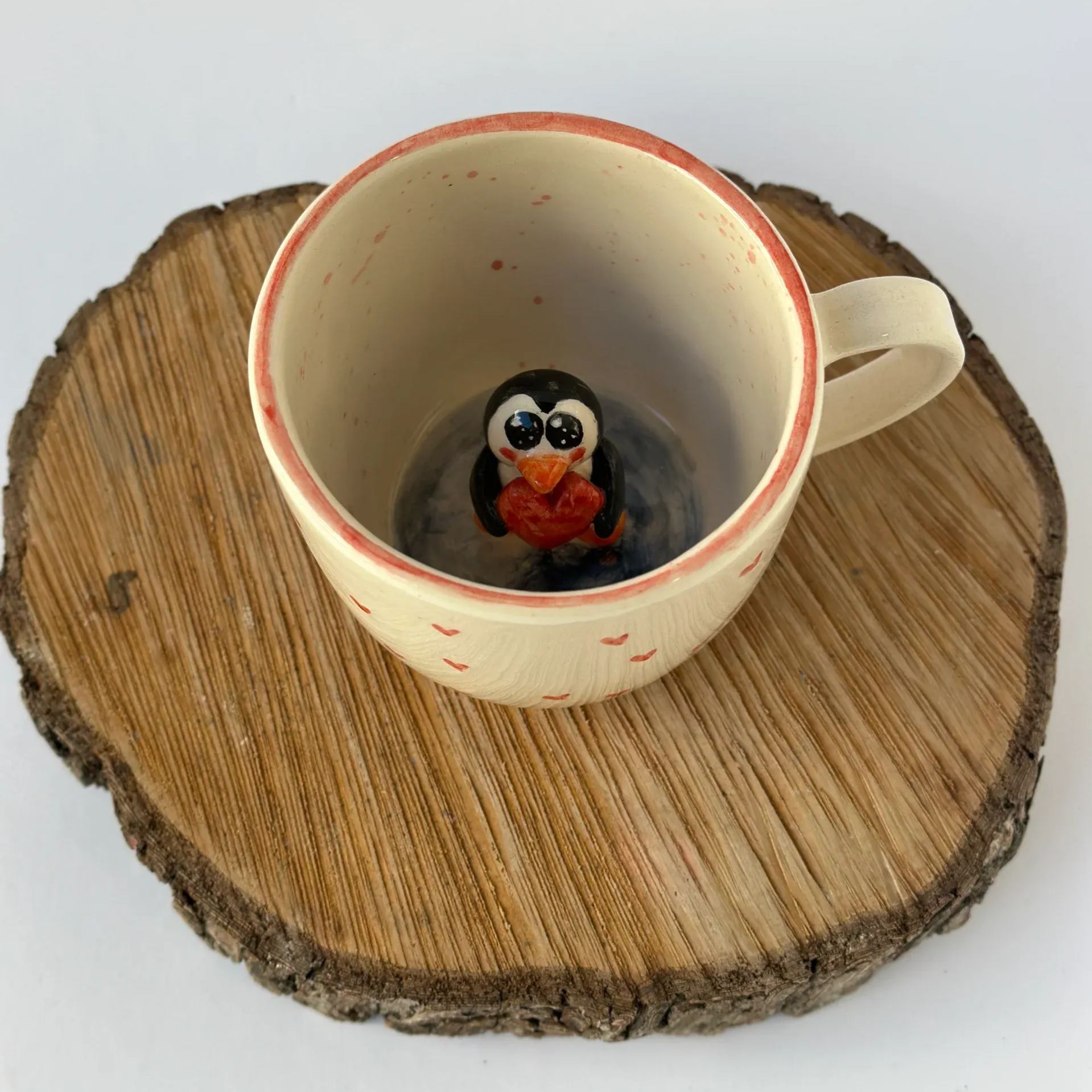 Handmade ceramic mug with penguin animal design
