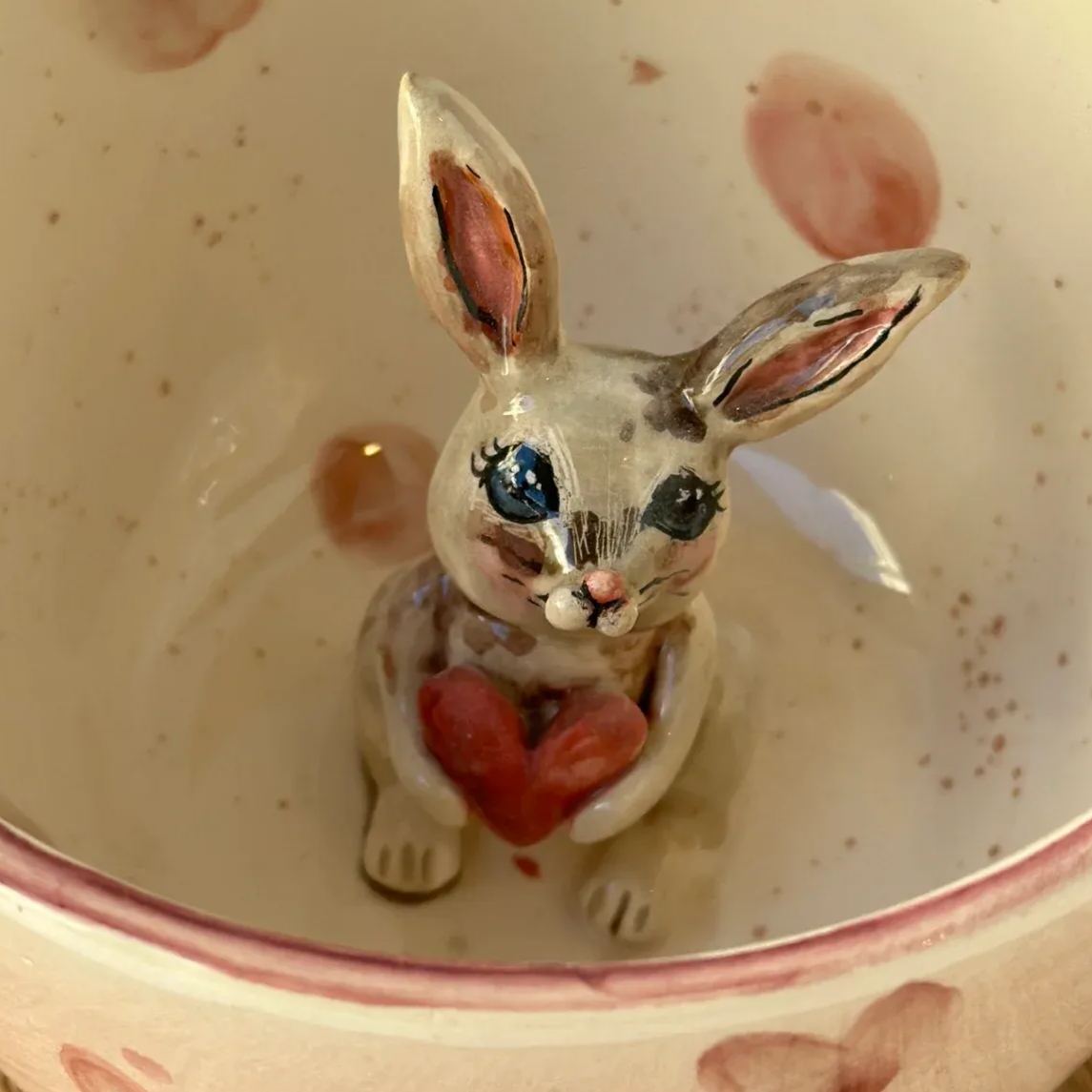 Handmade ceramic mug with rabbit design features