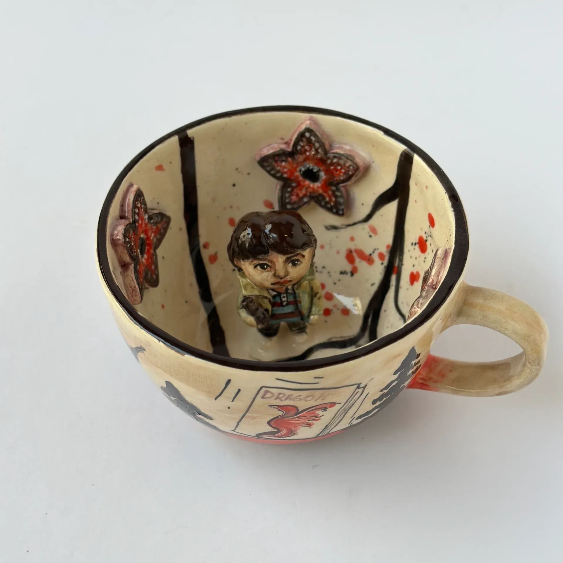 Handmade ceramic coffee mug with character portrait design