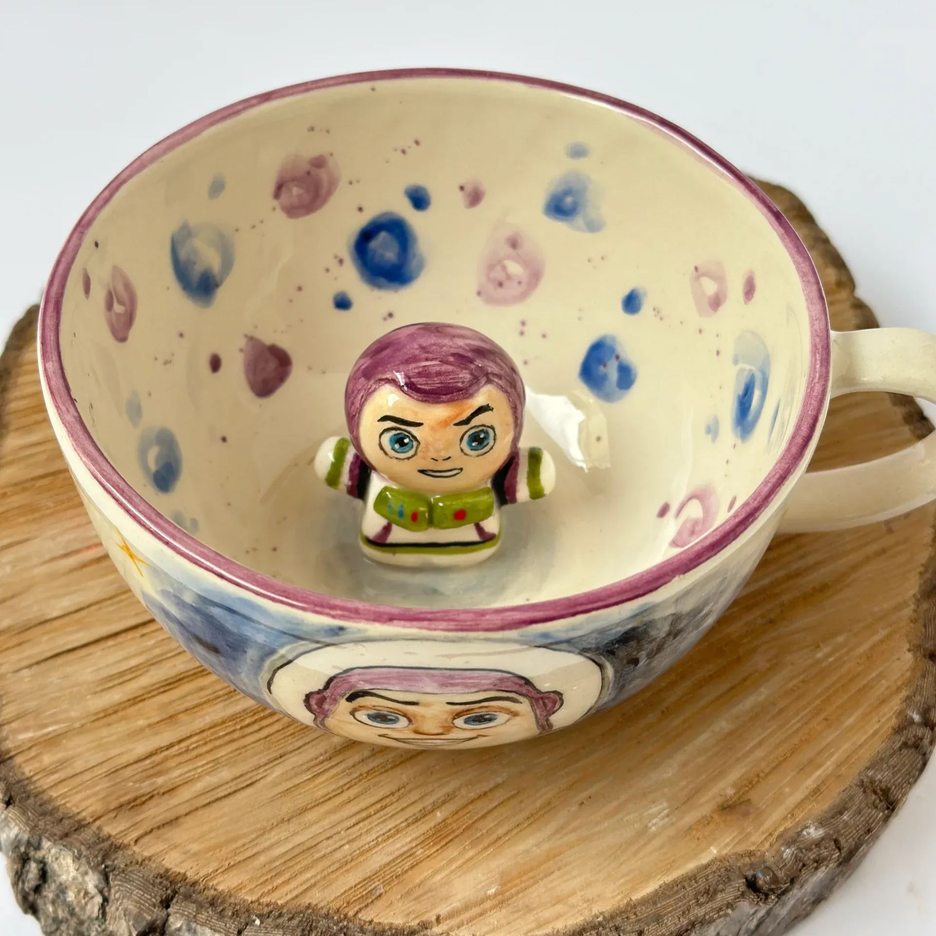 Handmade ceramic coffee mug with sculpted cartoon astronaut design