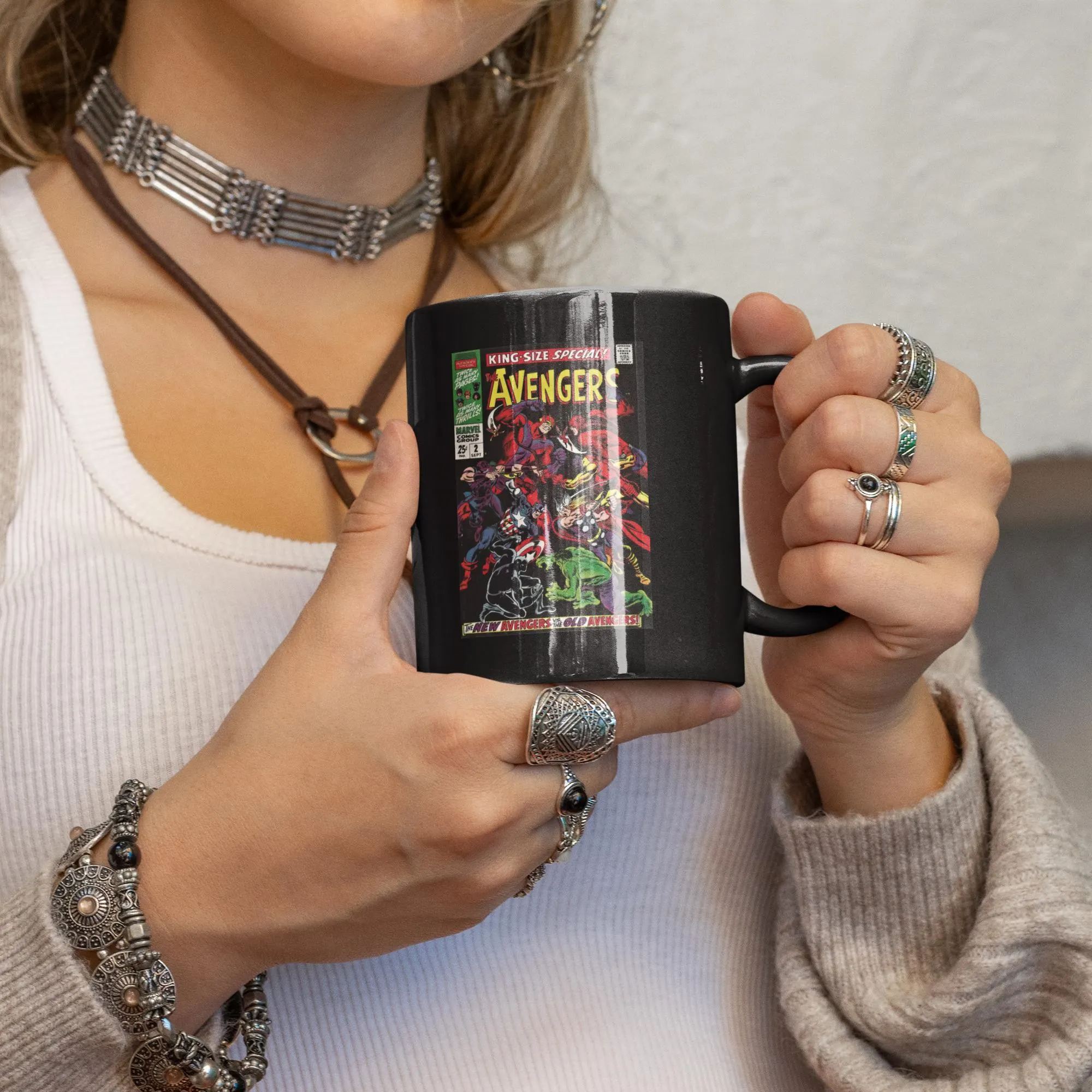 Person holding a ceramic mug with a vintage Avengers King Size Special comic book cover print