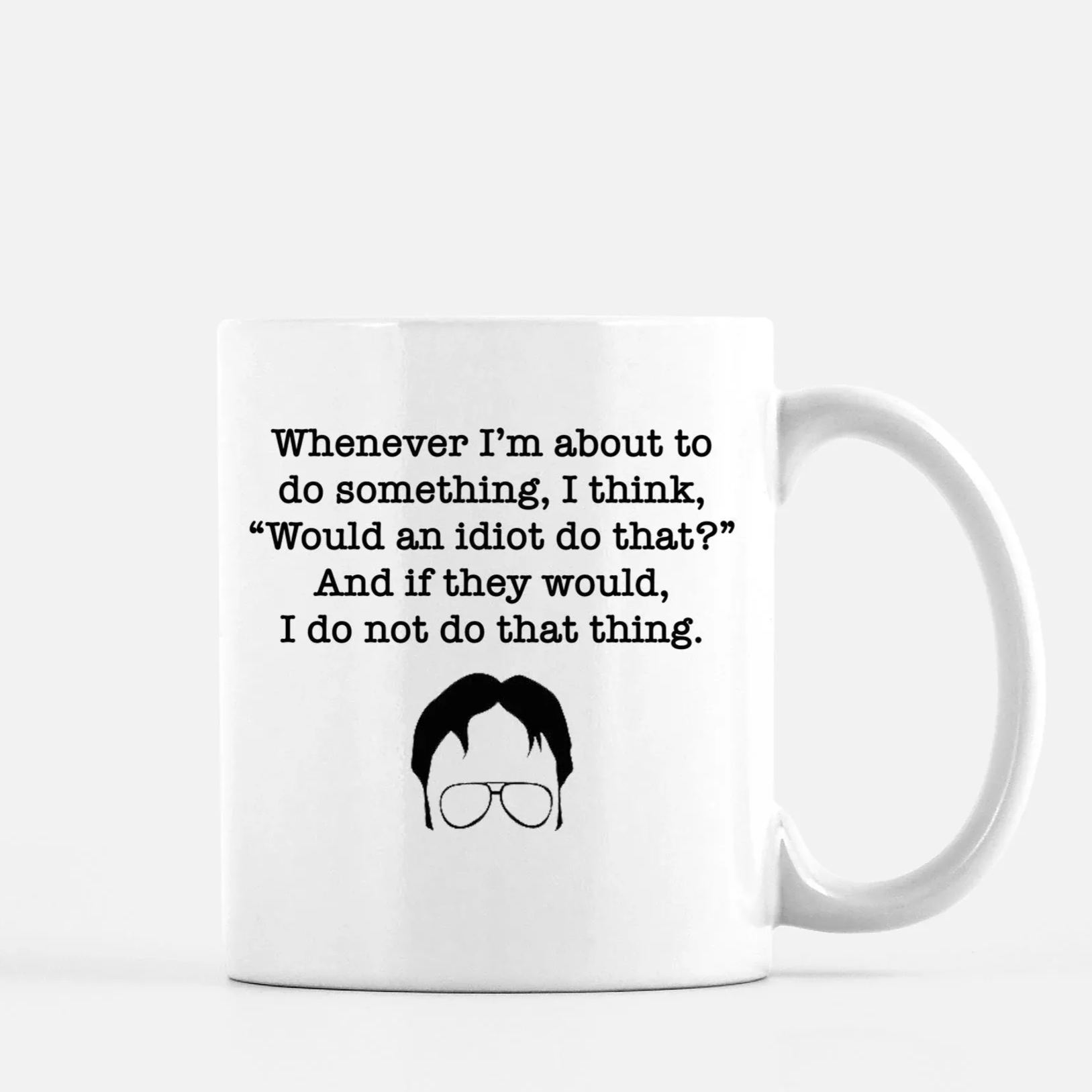 White ceramic mug featuring Dwight Schrute silhouette and quote about idiots