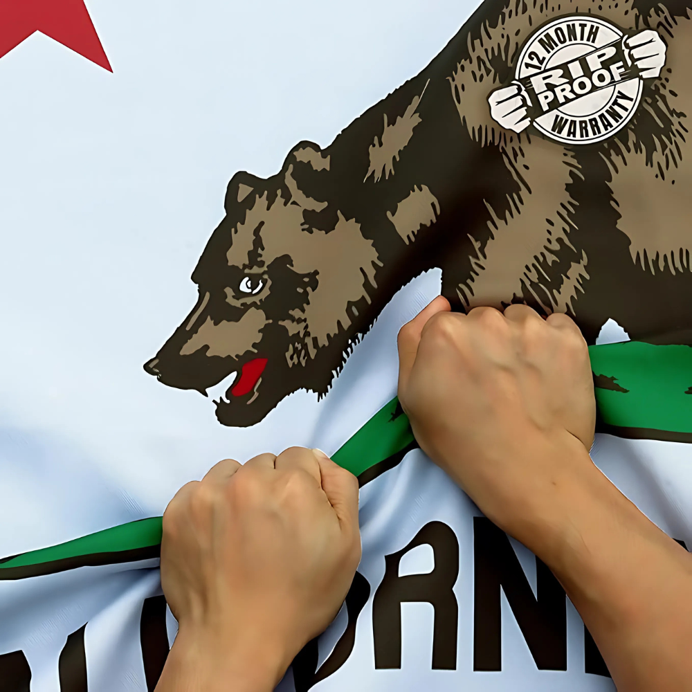 California State Flag With Grizzly Bear And Red Star flying on outdoor flagpole