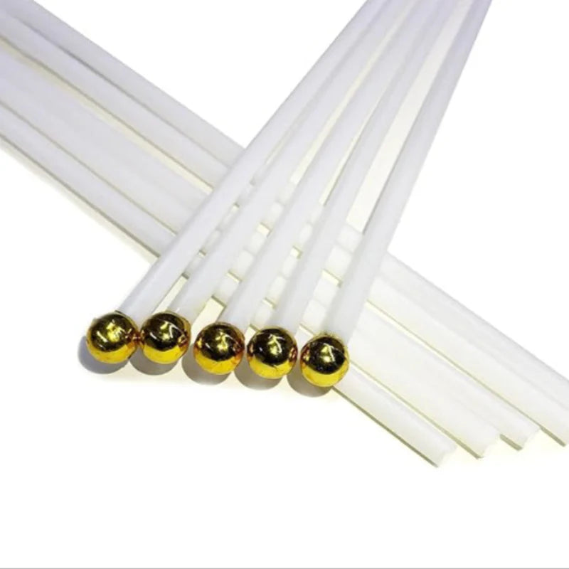 White plastic handheld flag poles with gold ball tops, arranged in a fan shape.