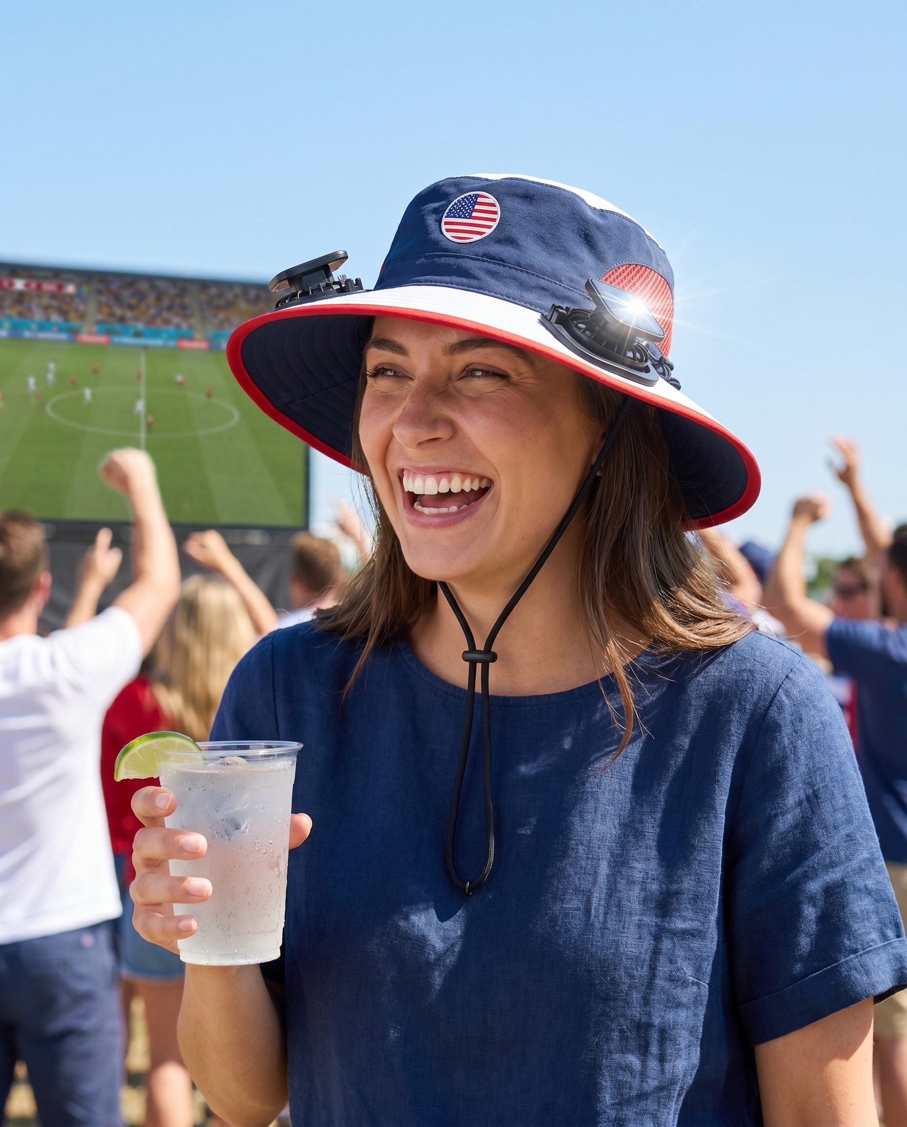 Woman wearing the USA solar cooling fan hat at a sunny World Cup watch party