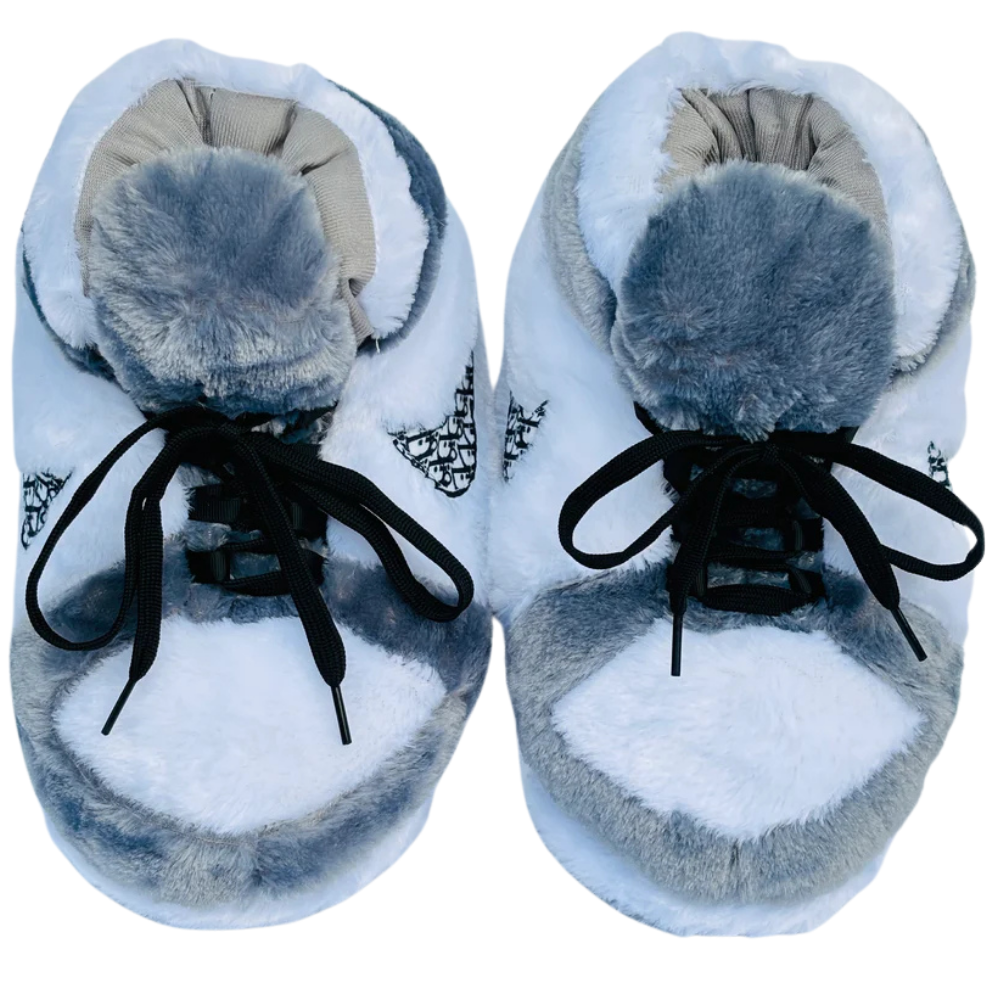 Top view of a pair of fuzzy gray and white sneaker-style slippers with black laces and patterned swoosh design.