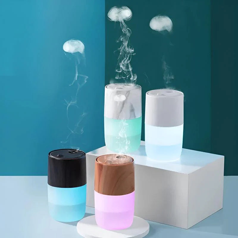 Four jellyfish-inspired humidifiers emitting mist with glowing LED lights, displayed on white stands against a teal background.