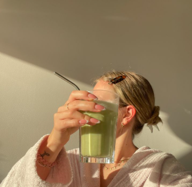 A elegant woman incorporating matcha into her workday for sustained focus and energy.