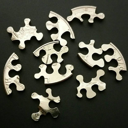 Puzzle cut from a Kennedy half dollar