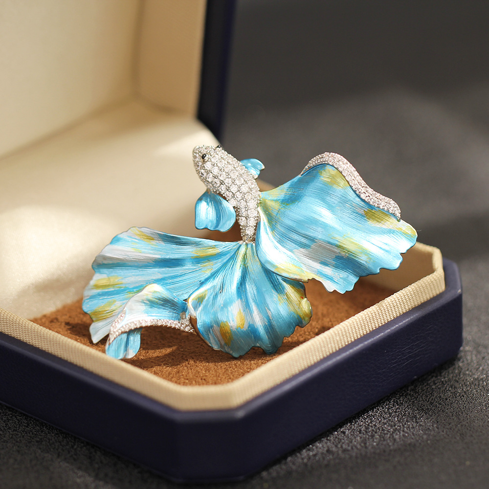 Light luxury high-end enamel blue and red flowing flying fish brooch, exquisite marine creature pin for men and women