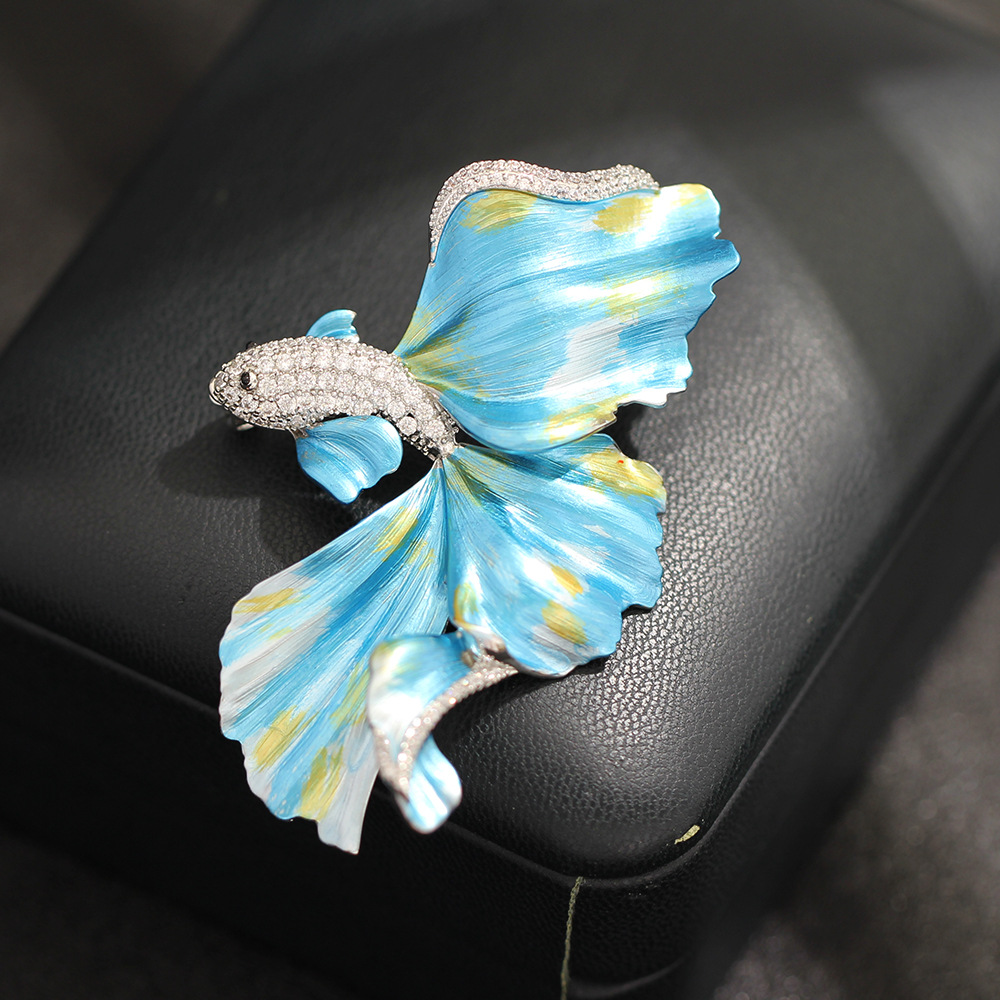 Light luxury high-end enamel blue and red flowing flying fish brooch, exquisite marine creature pin for men and women