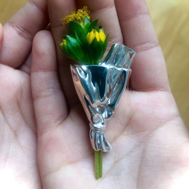Close-up side view of the polished alloy flower holder pin
