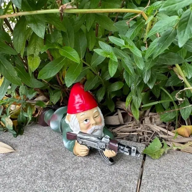 Three dwarf soldiers holding AK-47 rifles