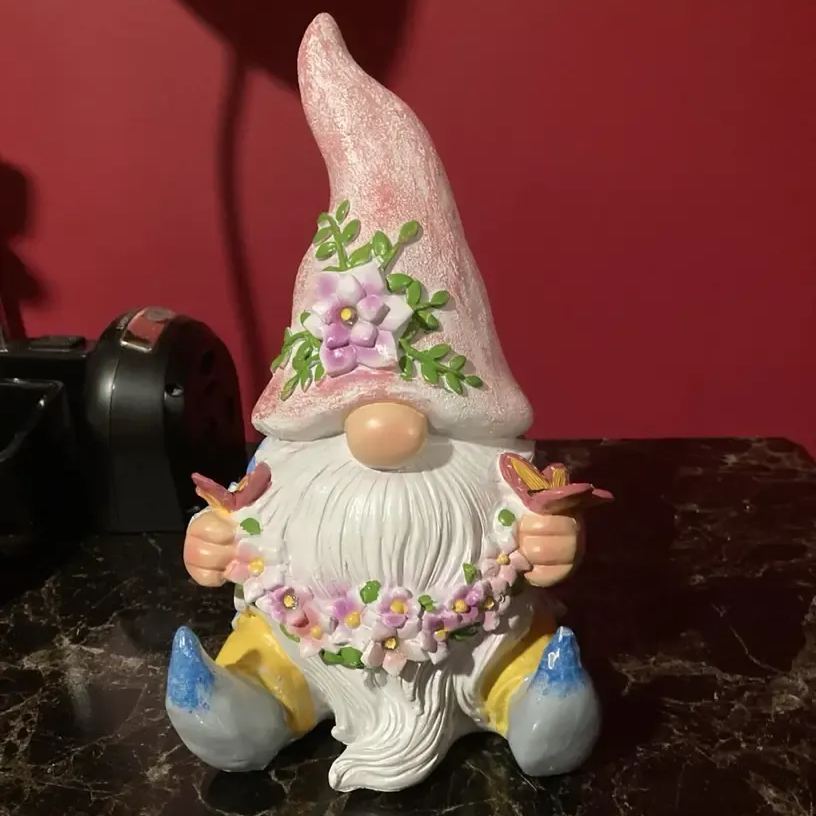 Dwarf sculpture holding a butterfly with Solar LED Lights