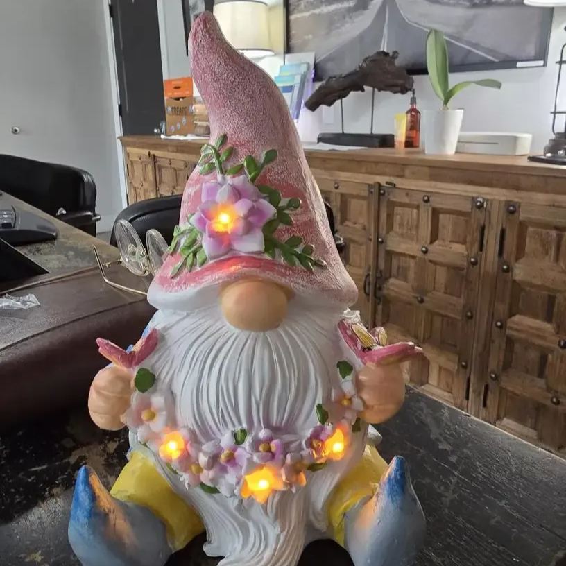 Dwarf sculpture holding a butterfly with Solar LED Lights