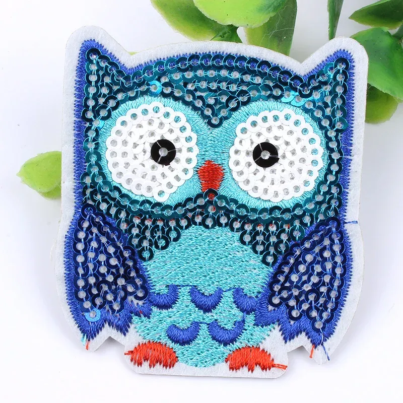 A blue and white owl embroidered patch.
