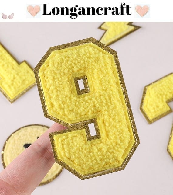 A yellow number chenille patch
