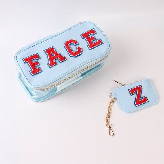 A blue makeup bag with the letter z on it.