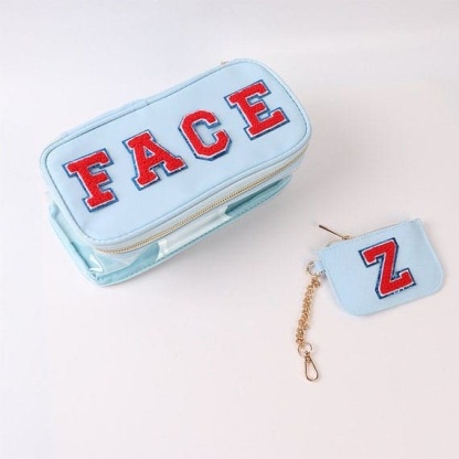 A blue makeup bag with the letter z on it.