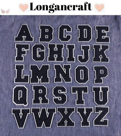 A set of blue letter embroidered patches.