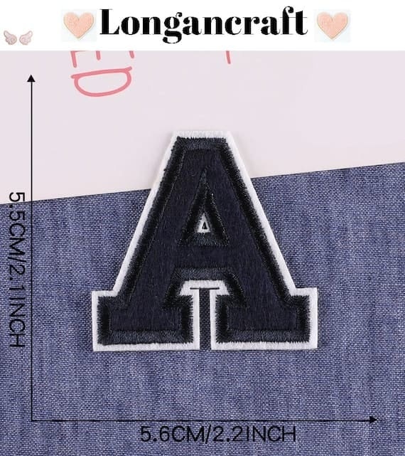 The letter a embroidered on a denim shirt.