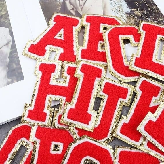 A set of red and gold alphabet Chenille Patches