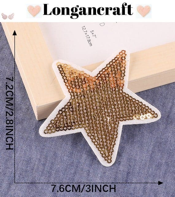A gold sequin star is sitting next to a frame.