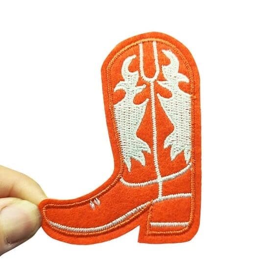 An orange cowboy boot embroidered patch.