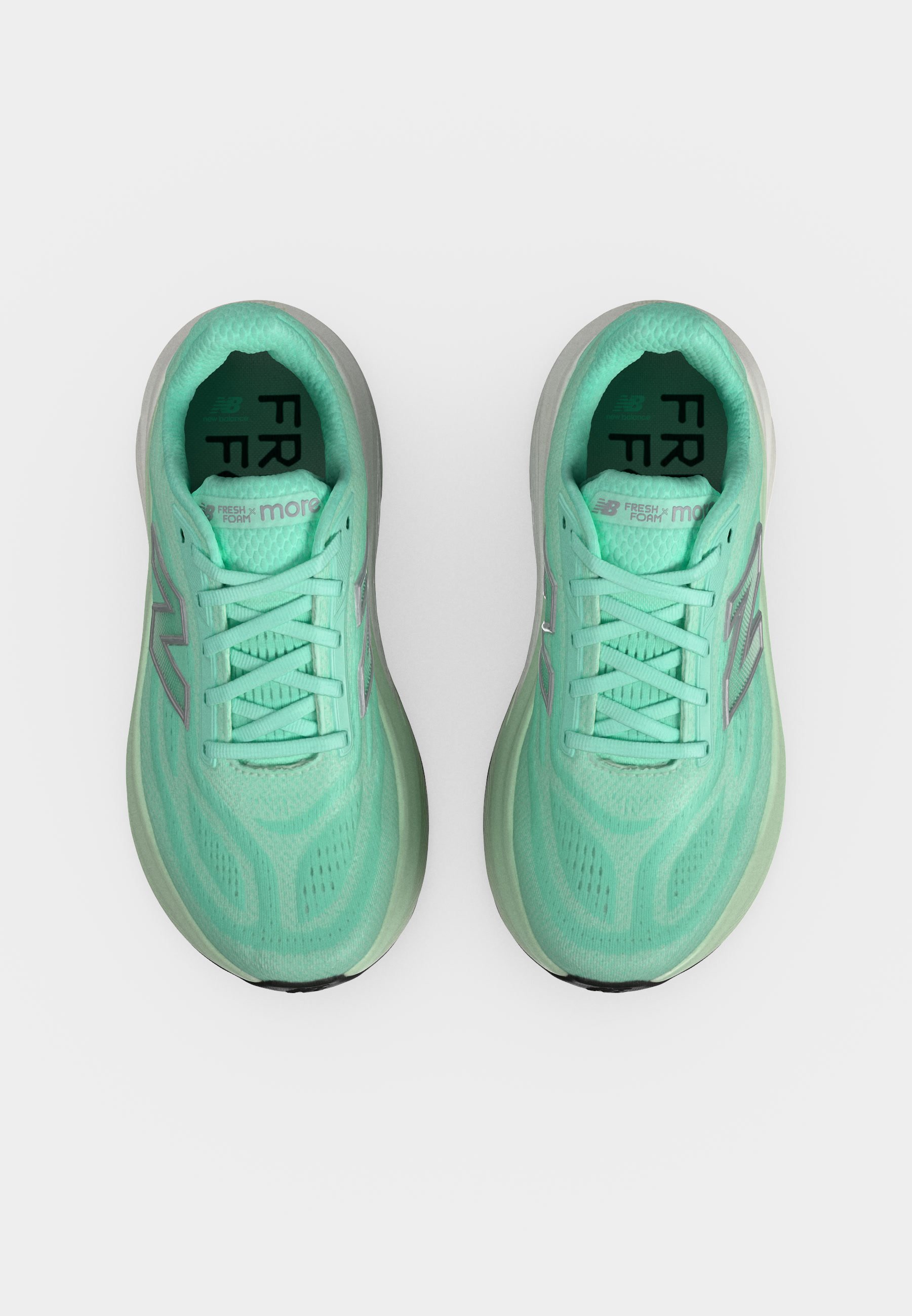 Par de zapatillas deportivas verde menta con diseño de cordones y suelas acolchadas vistas desde arriba sobre un fondo blanco.