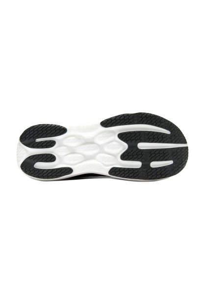 Suela de zapatilla en blanco y negro con un patrón ondulado y texturizado de goma negra y áreas acolchadas blancas, con bordes redondeados y ranuras flexibles.