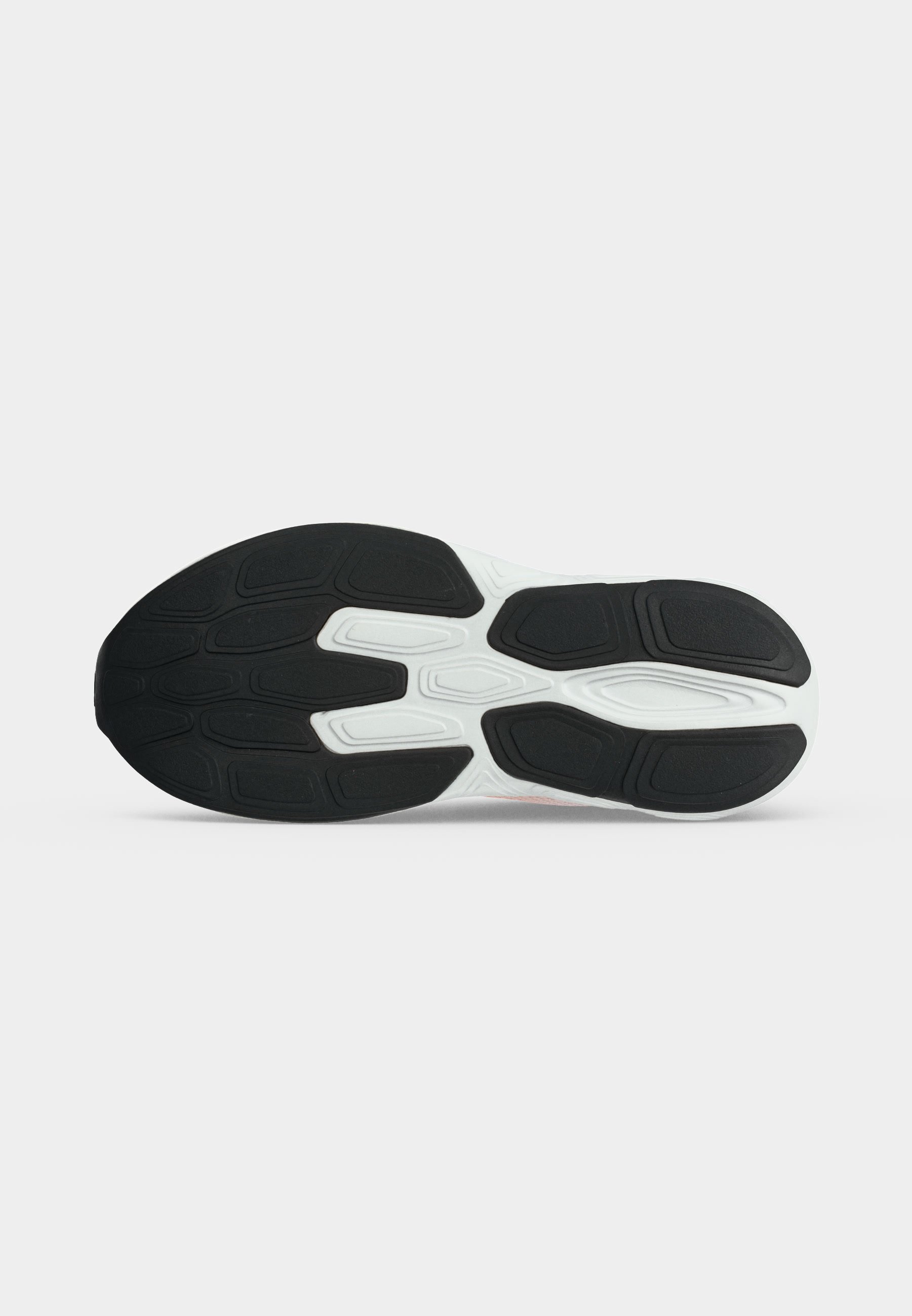 Suela de un zapato deportivo con patrones de goma en blanco y negro diseñados para agarre y durabilidad.