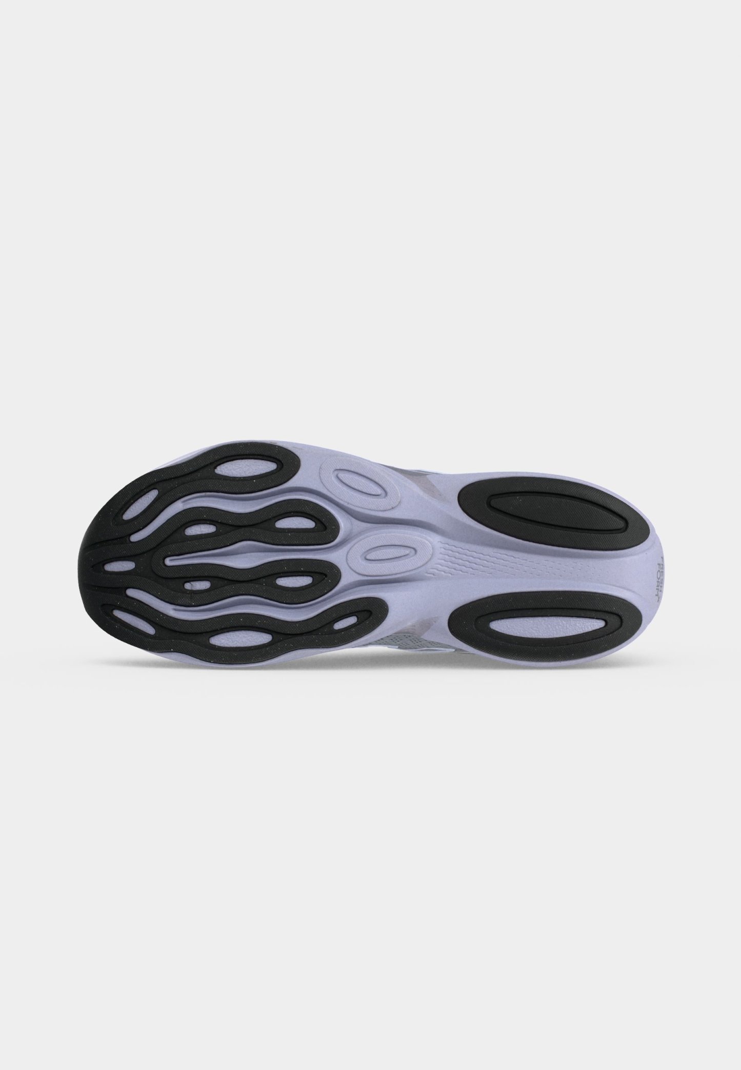 Suela de un zapato deportivo con almohadillas de tracción de goma negra en una suela exterior de color claro, diseñada para agarre y flexibilidad.
