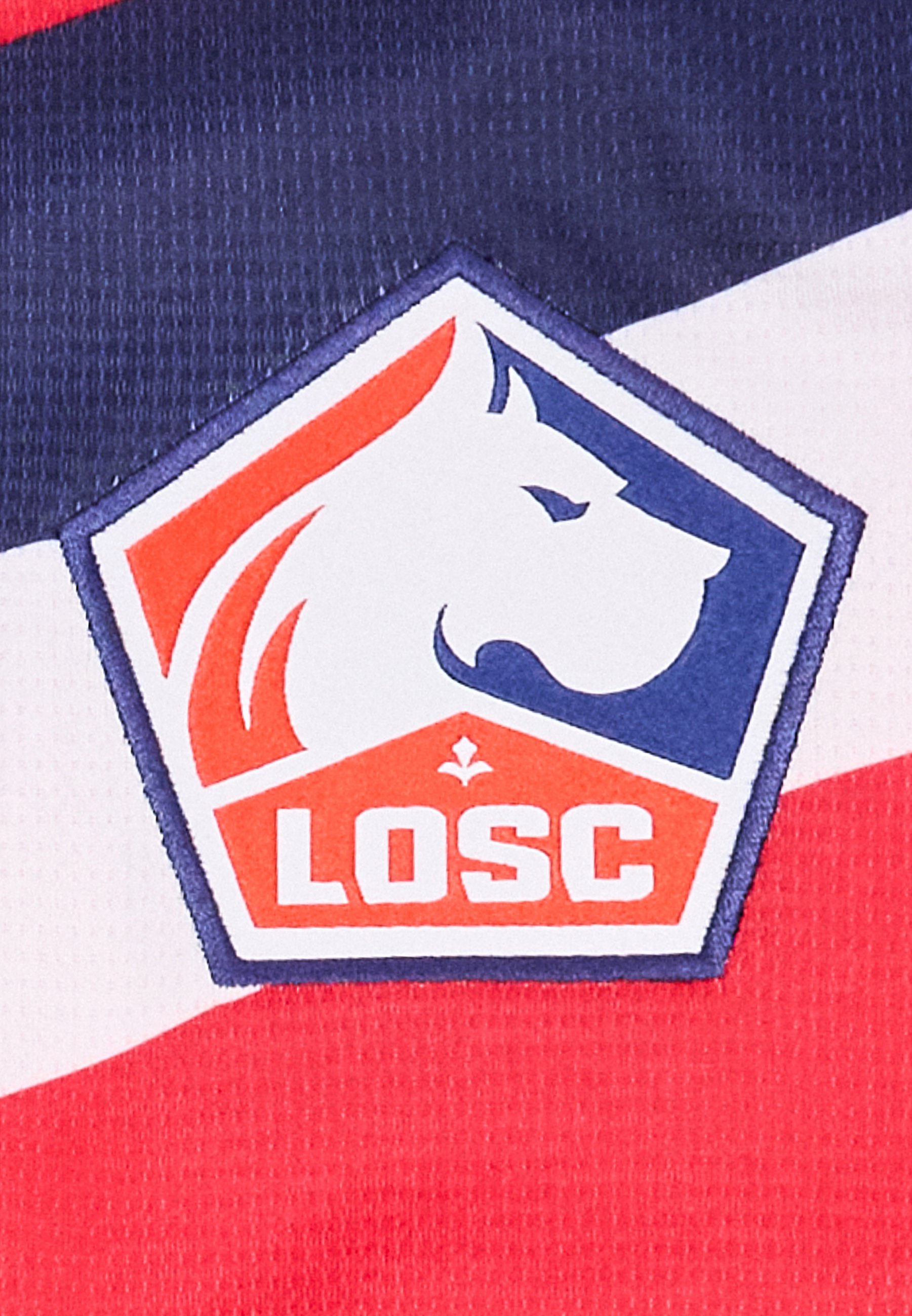 Logotipo hexagonal con una cabeza de perro blanca mirando hacia la derecha, fondo rojo y azul, y las letras LOSC en blanco negrita sobre rojo.