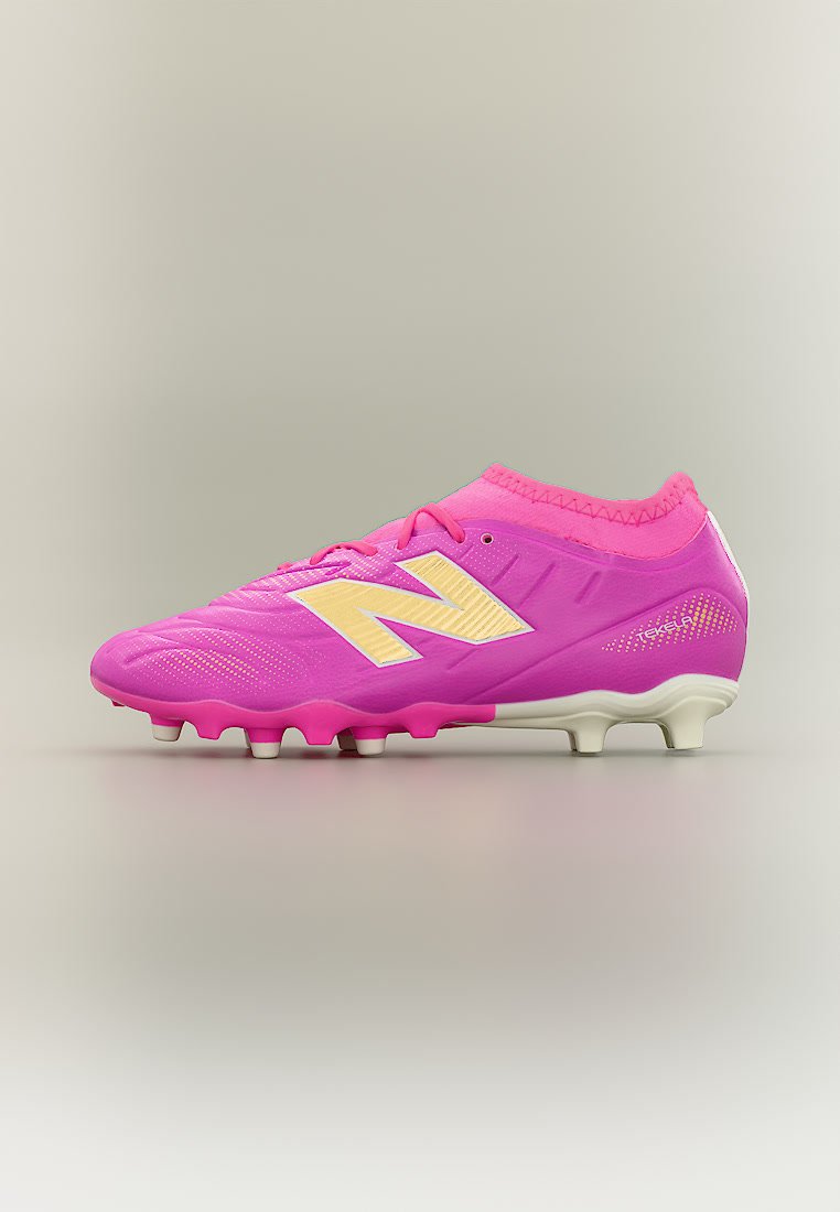Botín de fútbol de color rosa brillante con logotipo "N" amarillo, tacos moldeados y cuello tipo calcetín sobre fondo neutro.