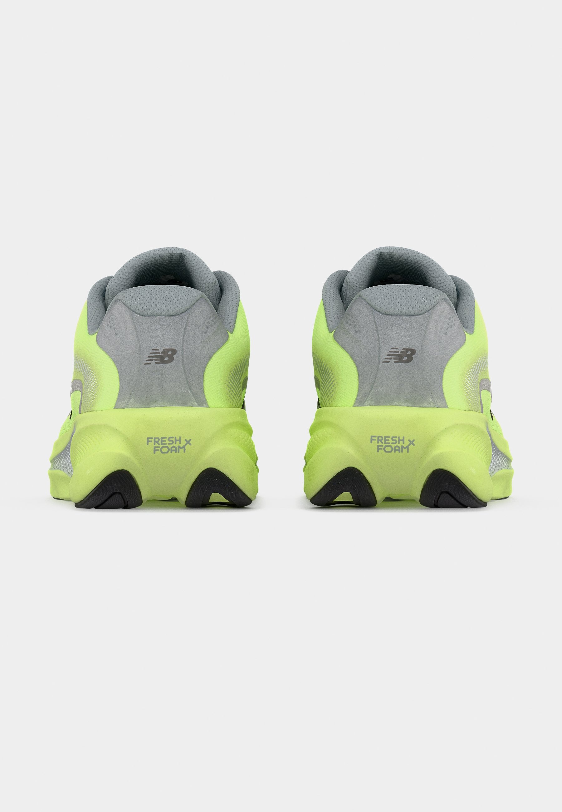 Zapatillas de correr de color amarillo neón con parte superior de malla gris, collarín acolchado en el talón y suela de goma negra con la marca "FRESH FOAM" en el talón.