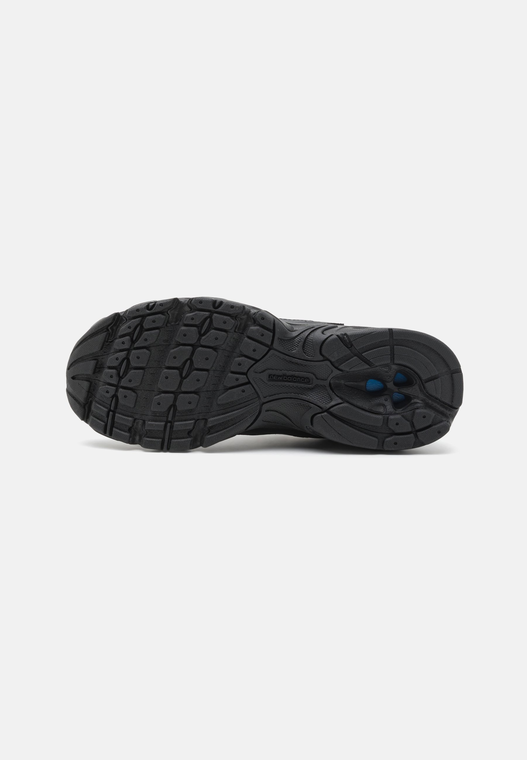 Suela de zapato atlético negro con una banda de rodadura de goma estampada, que presenta ranuras y elementos de tracción, diseñada para agarre y durabilidad.