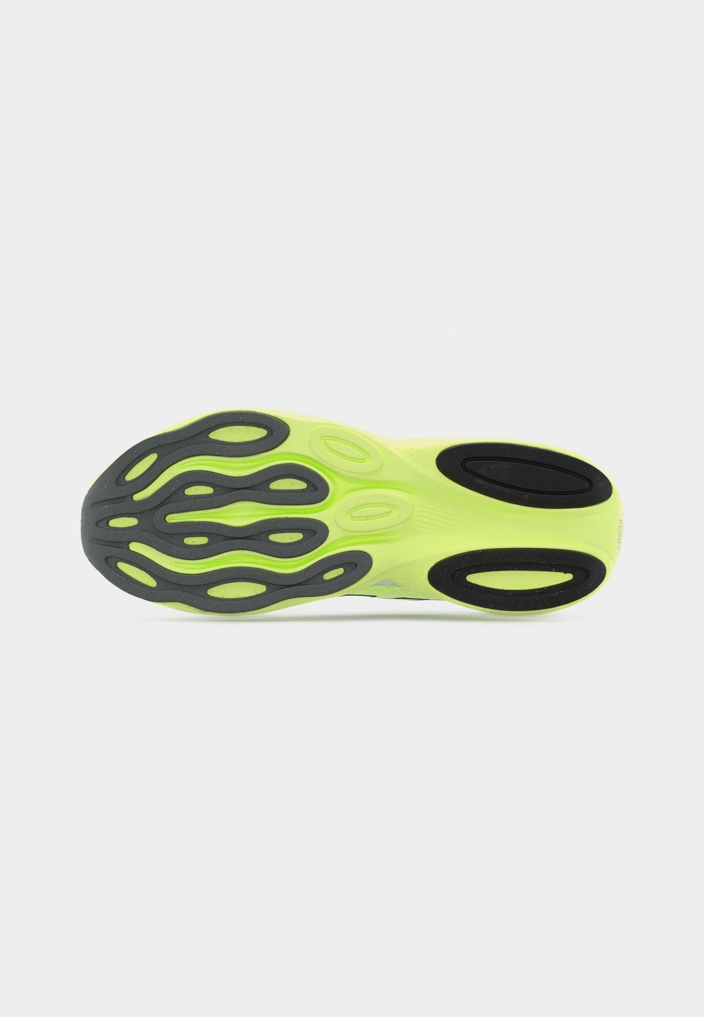 Suela de zapato deportivo de color verde neón con patrones de tracción negros, mostrada sobre un fondo blanco.