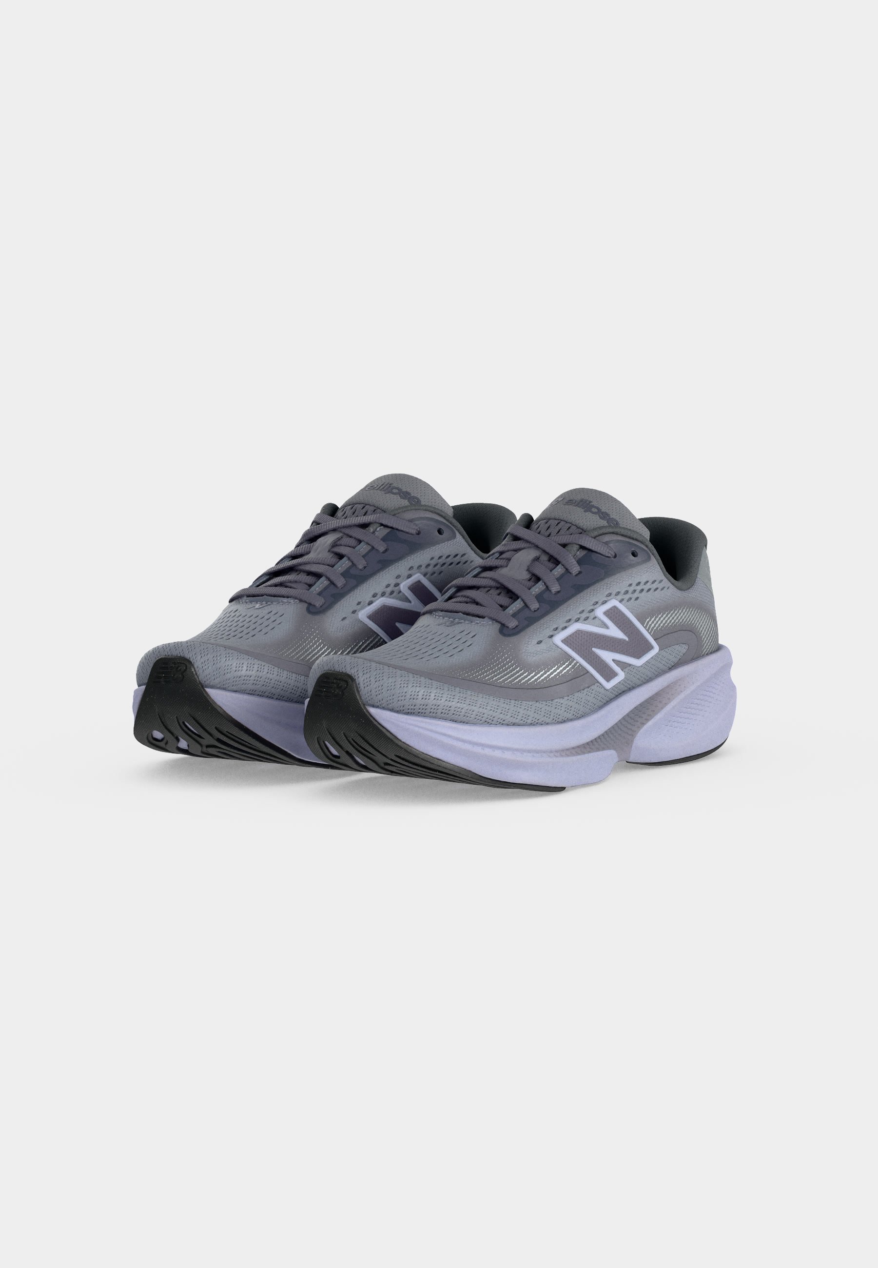 Par de zapatillas de running New Balance grises con suelas blancas gruesas, suelas exteriores negras y parte superior de tela de malla inclinadas hacia adelante sobre un fondo blanco.
