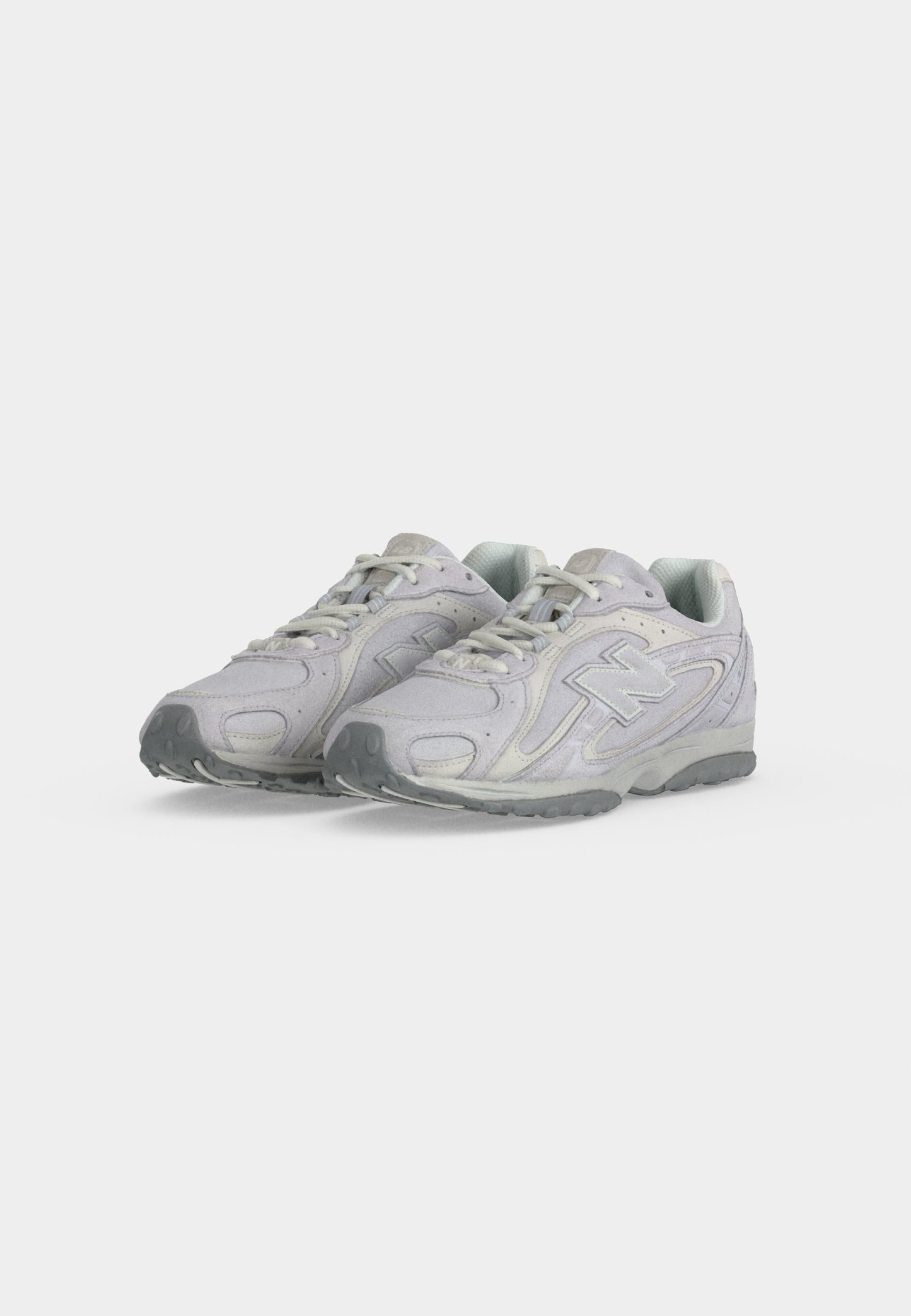 Par de zapatillas deportivas de color gris claro con cordones y suelas texturizadas, colocadas una al lado de la otra sobre un fondo blanco liso.