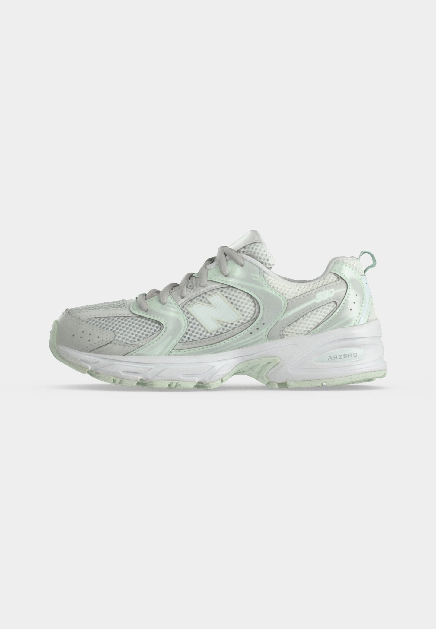 Zapatilla deportiva blanca y verde pálido con parte superior de malla y sintética, cierre con cordones y suela acolchada con tecnología ABZORB.