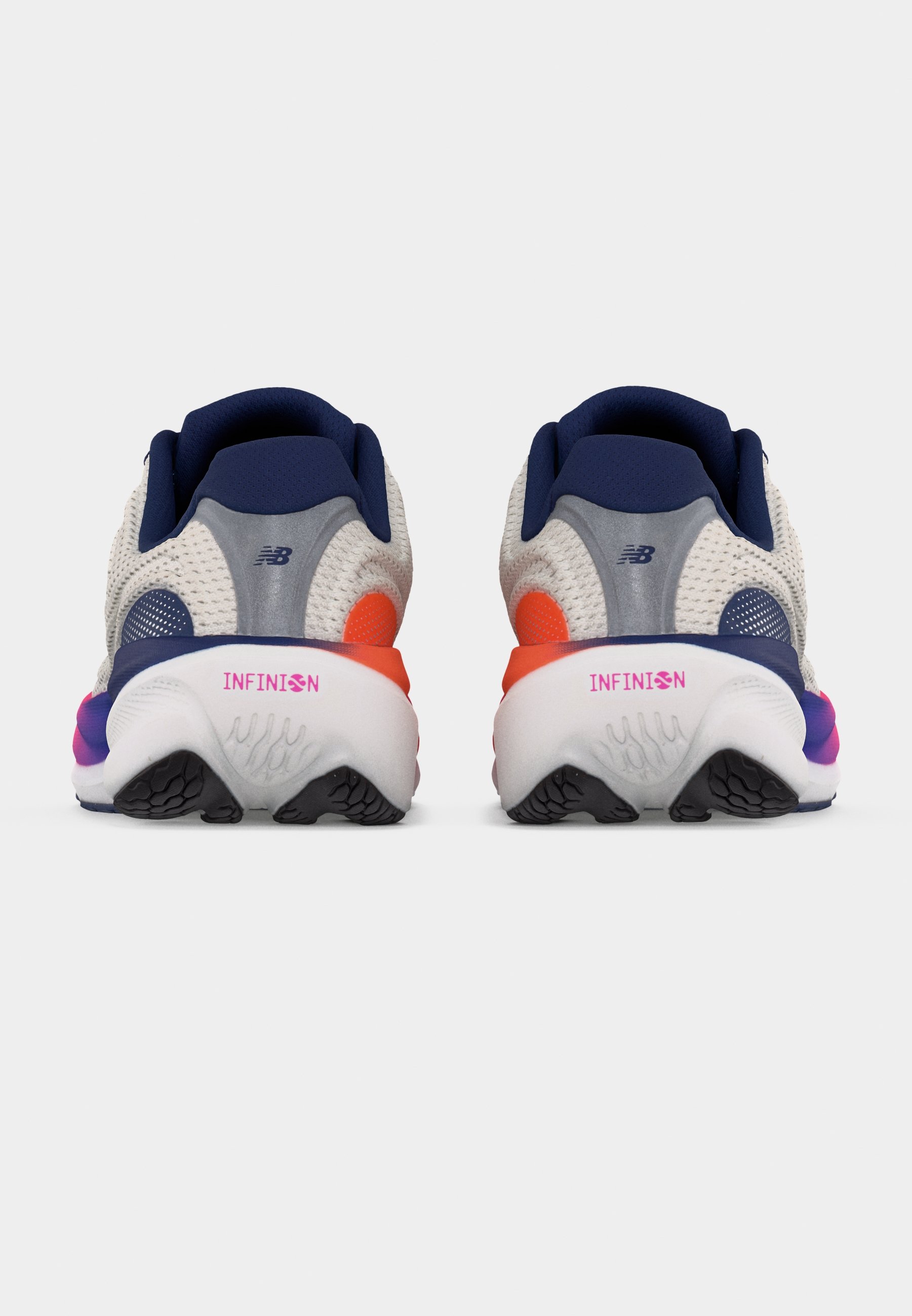 Par de zapatillas de correr blancas y azul marino con detalles en naranja y rosa, vistas desde atrás, mostrando la marca "INFINION" en las medias suelas.